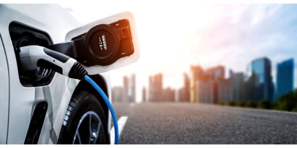 A car at an EV charging station in a metropolitan city.
