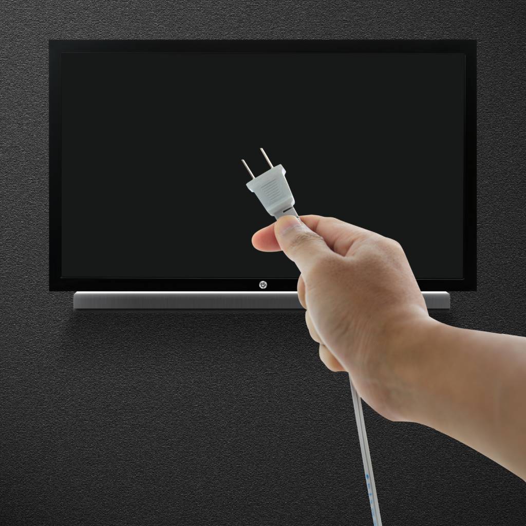 A hand unplugging a television plug